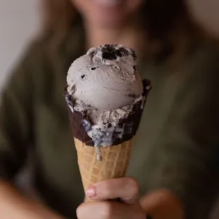 cookies and cream in a chocolate dipped waffle cone