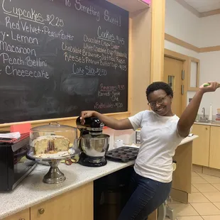 a woman standing in front of a chalkboard