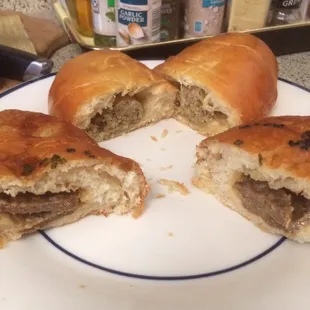 Boudin klobasnek &amp; patty melt ( spicy pan sausage and cheese ) croissant.