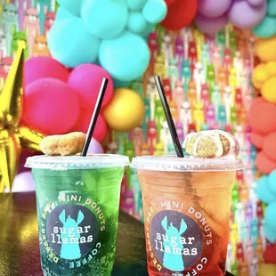 two drinks with straws and a donut