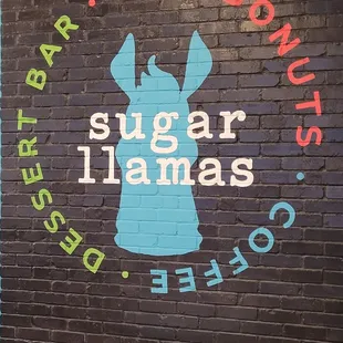 a sign on a brick wall