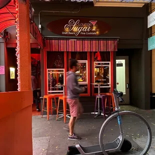 a man riding a scooter in front of a store
