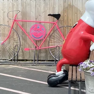 a pink bicycle behind a fence