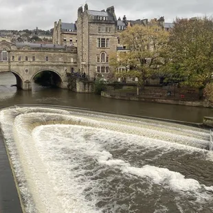 a view of a river flowing under a bridge
