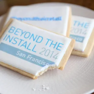 Custom cookies made for a corporate event - screen-printed logo on one, hand-piped hashtag on the other.