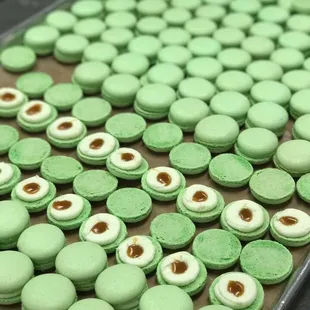 a tray of green macarons
