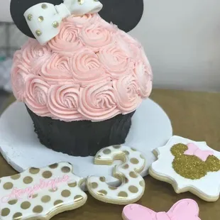 a minnie mouse cupcake and cookies