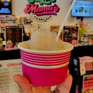 a hand holding a cup of ice cream