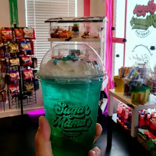 a hand holding a cup of ice cream