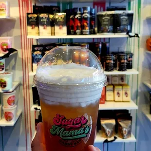 a hand holding a cup of ice cream