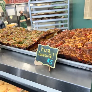 a variety of pizzas on display