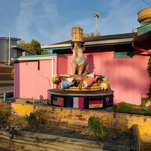  statue of a man sitting on a table