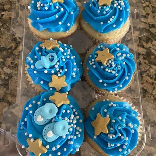 six cupcakes with blue frosting