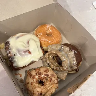 Cream cheese cinnamon bun, maple bacon donut, blueberry, chocolate, &amp; glazed