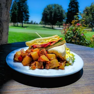 Open 7:00 a.m. daily! Pictured is a breakfast ham n egg sando, we love our country potatoes!!