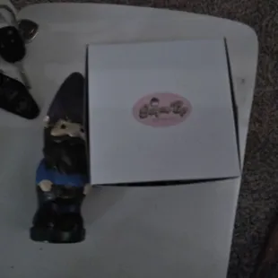 a small gnome with a box on a table