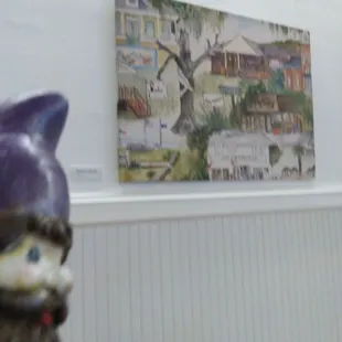 a figurine of a gnome with a purple hat