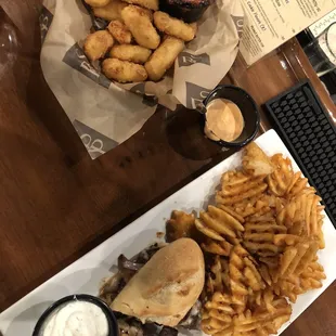 Gouda cheese bites and steak sandwich with waffle fries