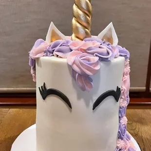 a cake decorated with a unicorn&apos;s horn