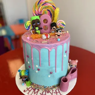 a cake decorated with lollipops and lollipops