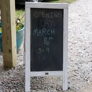 a chalkboard with the date of opening 3 a march