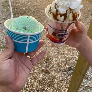 a hand holding a cup of ice cream and a hand holding a cup of ice cream