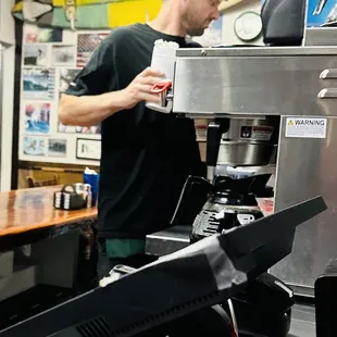 a bari preparing a cup of coffee