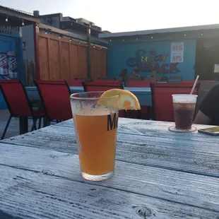 a glass of beer on a wooden table