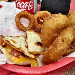 a basket of onion rings, onion rings, and cheese