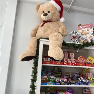 a teddy bear on top of a shelf