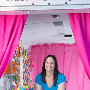 a woman behind a candy cart