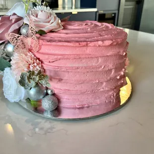 Lemon Cheesecake Birthday Cake, decorated with flowers and butterflies.