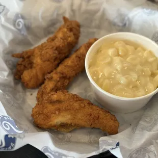 Chicken strip with a mac and cheese side.