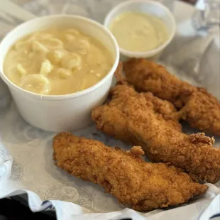 3 chicken strips with the side of mac and cheese and the cilantro crema dipper