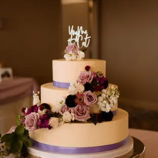 a wedding cake decorated with flowers
