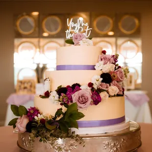 a wedding cake decorated with flowers