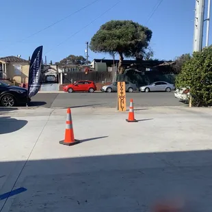 a parking lot with cars and cones