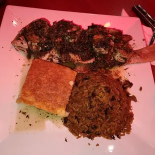Fried snapper topped with creole shrimp side of rice and peas and Macaroni pie