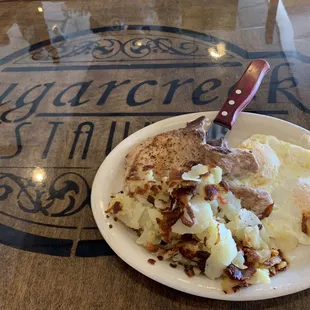 Pork chop with eggs and potatoes