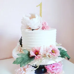 a white cake with pink flowers