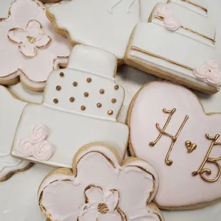 a table of decorated cookies for a wedding