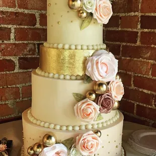 a three tiered wedding cake decorated with flowers