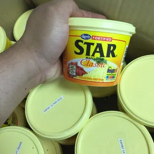 a hand holding a jar of star
