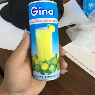 a person holding a can of gina