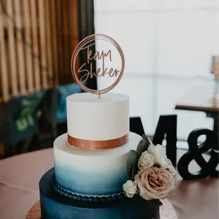 a three tiered cake with a rose on top