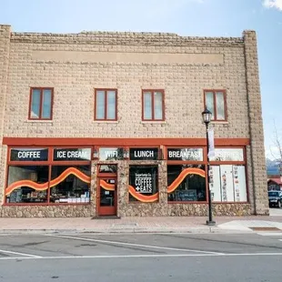 a coffee shop on the corner of a street