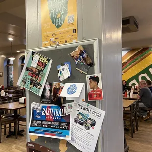 a refrigerator covered in posters