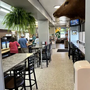 a deer head mounted on the wall of a restaurant