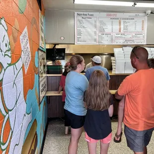 a group of people standing in front of a counter