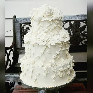 a wedding cake on a bench
